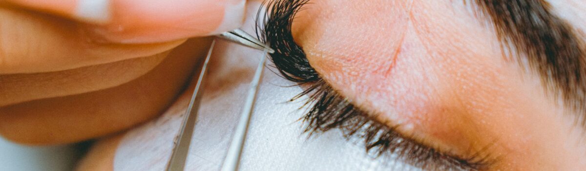 A close up of a person cutting a persons eye